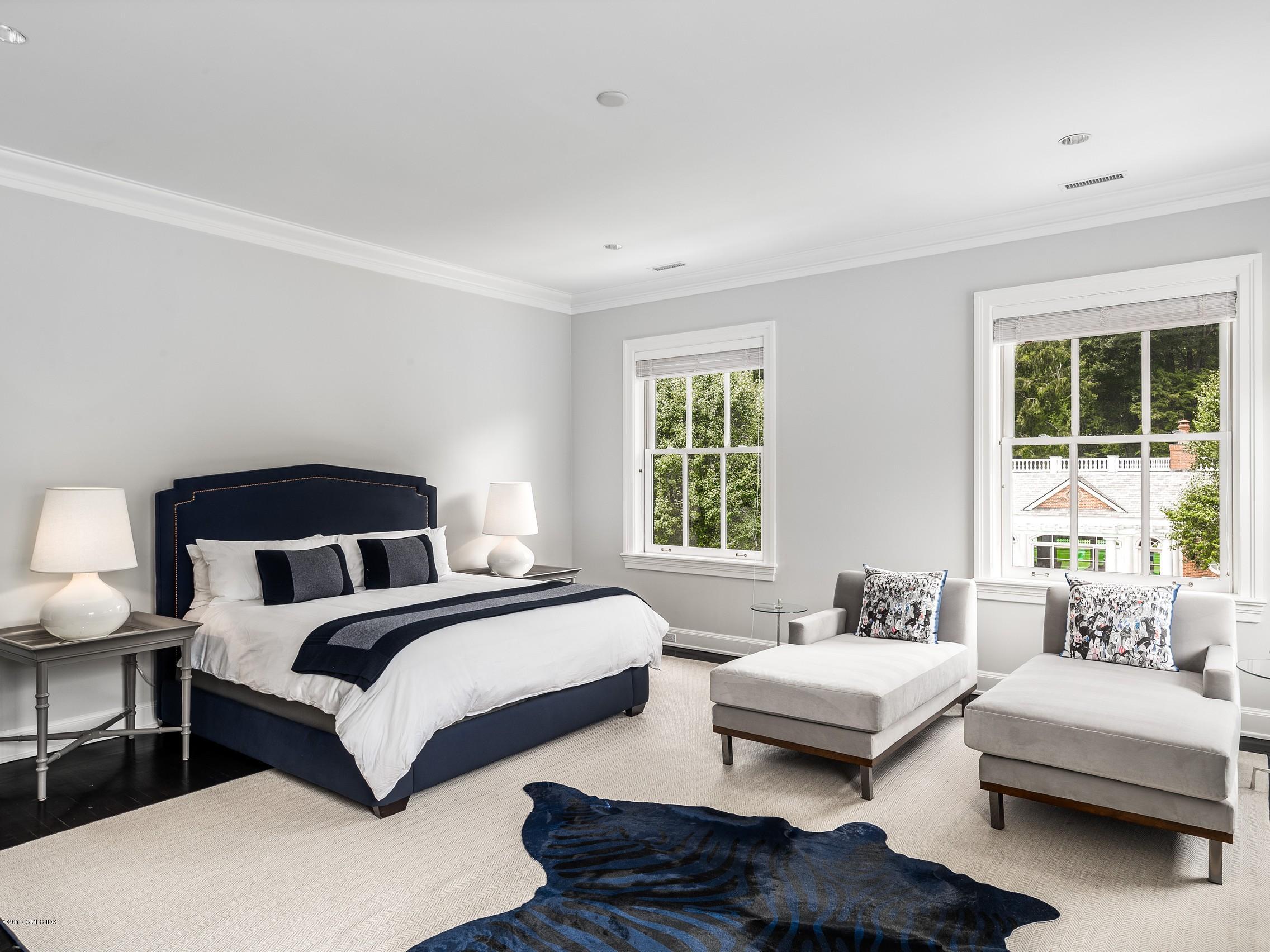 16 Andrews Farm Road Greenwich, CT 06831 - Photo 26 of 44 a spacious bedroom with a bed and a couch