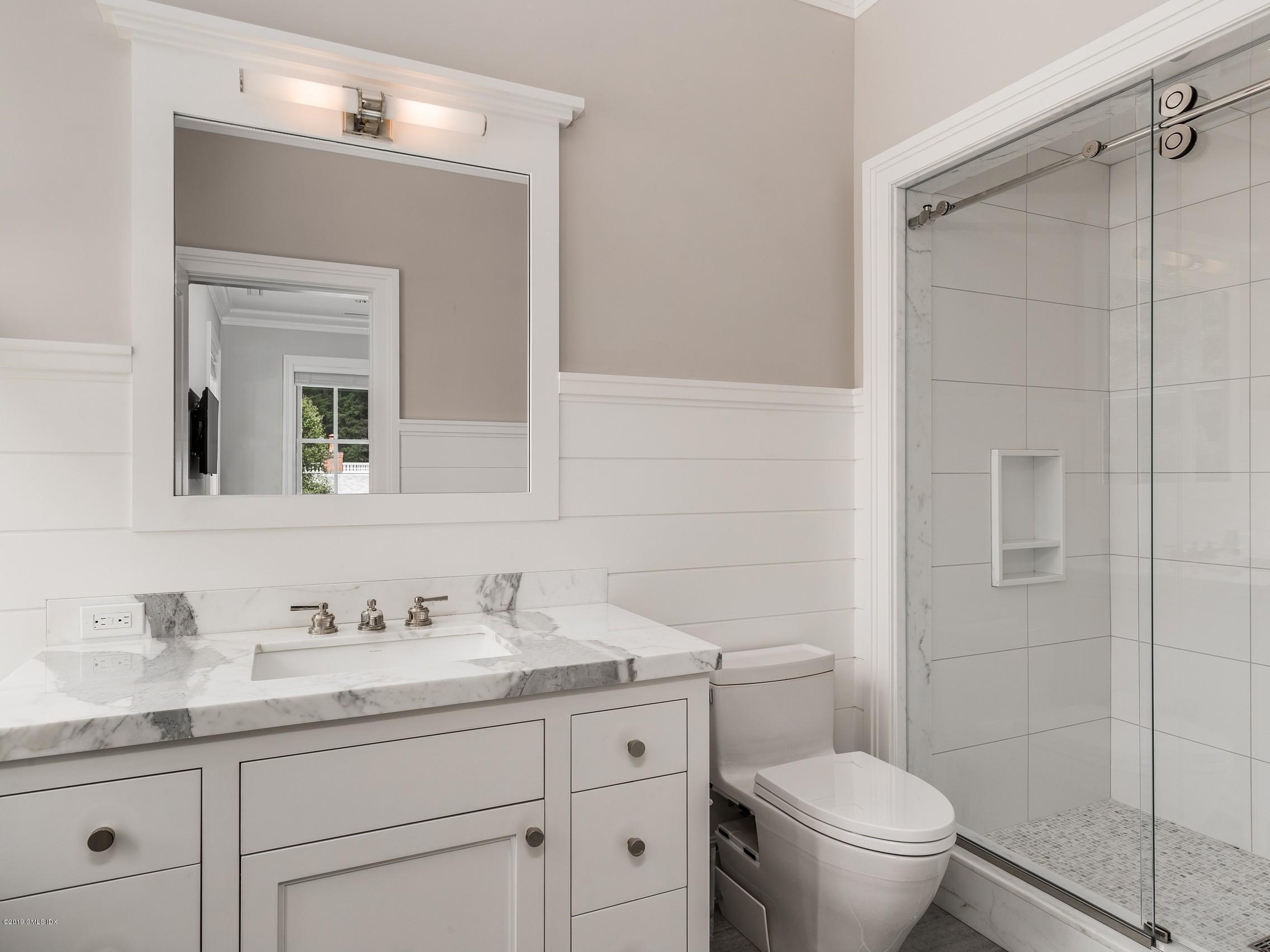 16 Andrews Farm Road Greenwich, CT 06831 - Photo 27 of 44 a bathroom with a granite countertop sink a toilet and a mirror