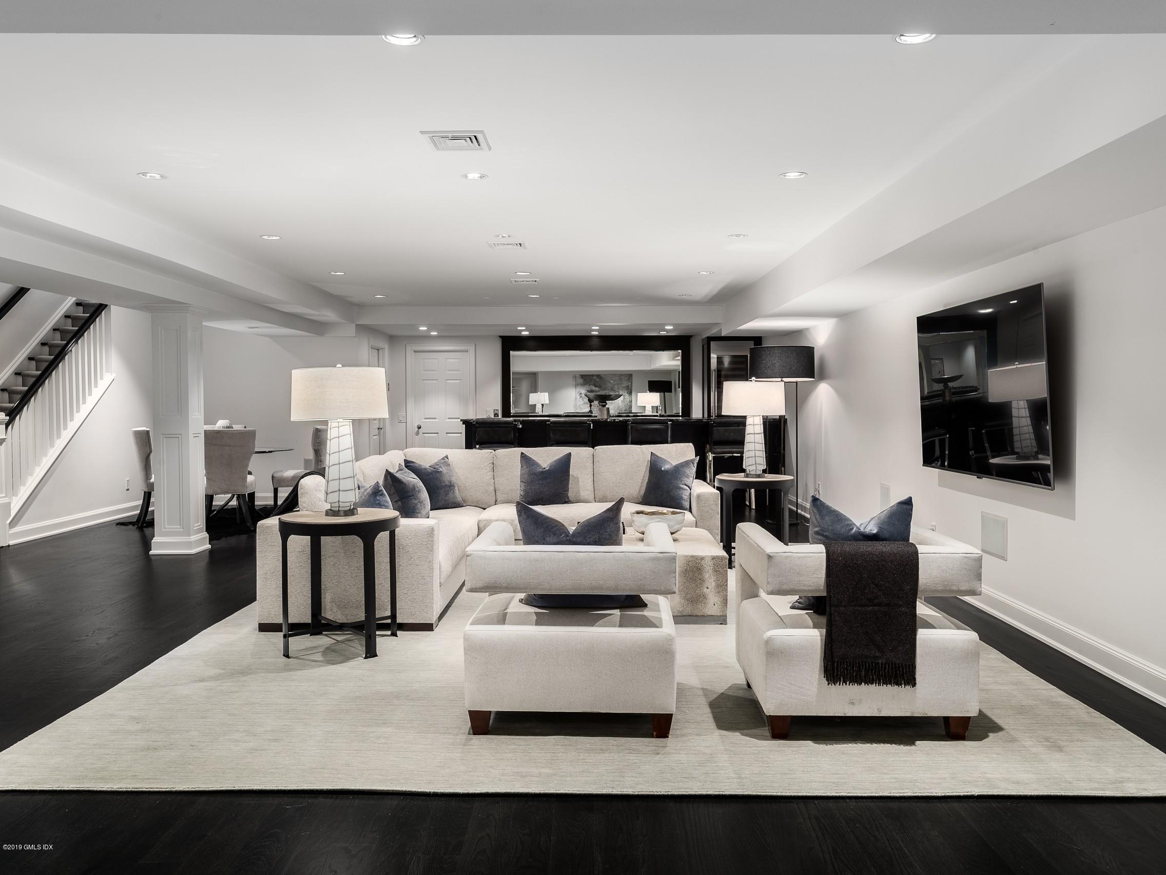 16 Andrews Farm Road Greenwich, CT 06831 - Photo 28 of 44 a living room with furniture flat screen tv and couches
