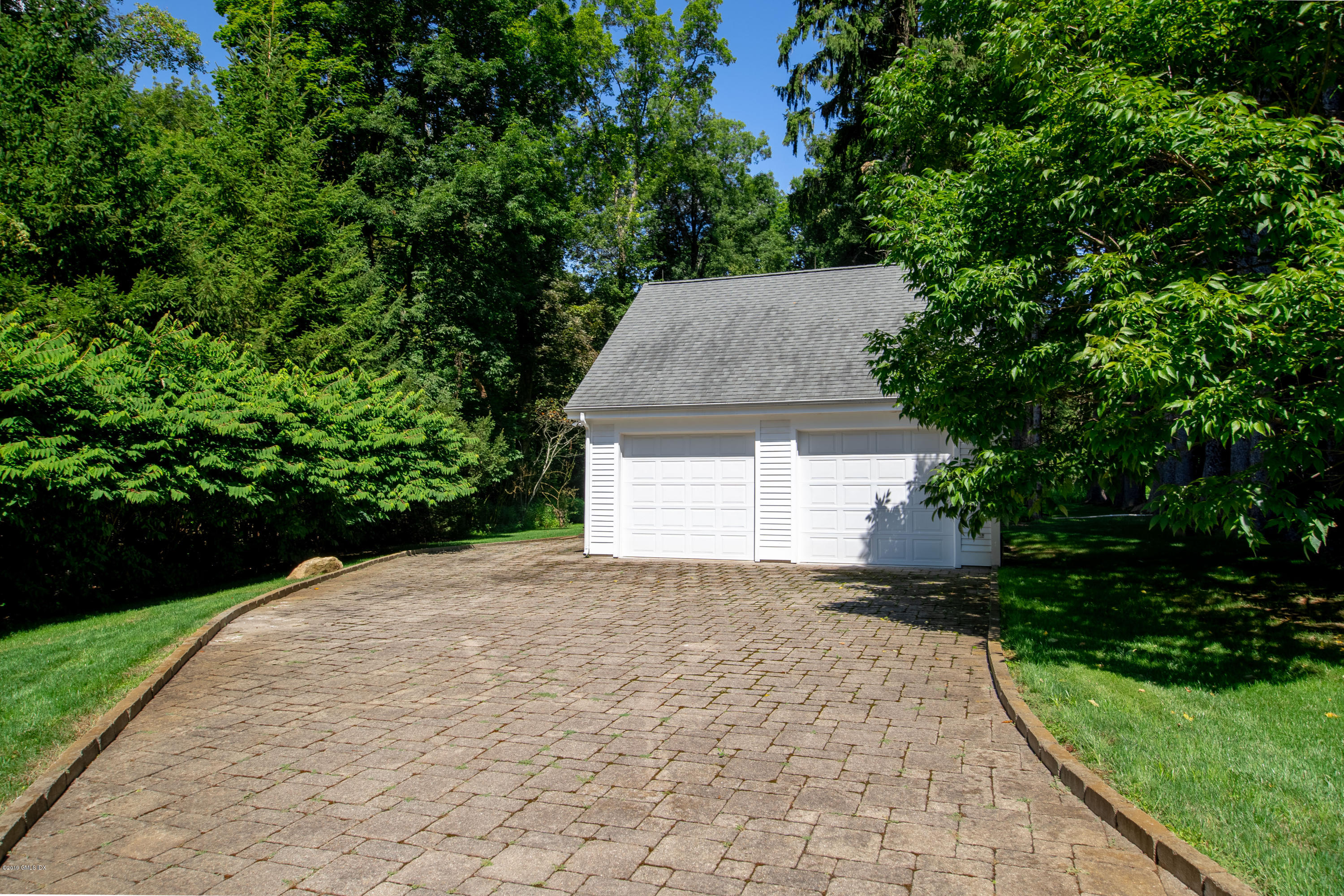 16 Andrews Farm Road Greenwich, CT 06831 - Photo 42 of 44 a view of a house with a yard and potted plants