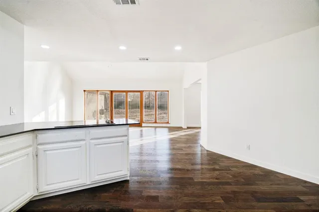 a view of kitchen with a refrigerator and wooden floor
