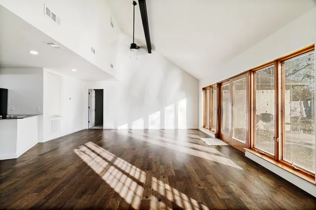 a view of a living room with kitchen appliances