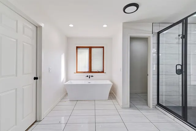 a large white kitchen with a sink and cabinets