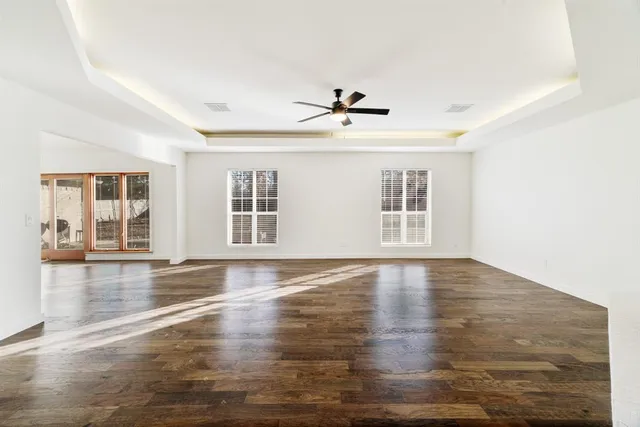 a kitchen with stainless steel appliances a refrigerator and white cabinets