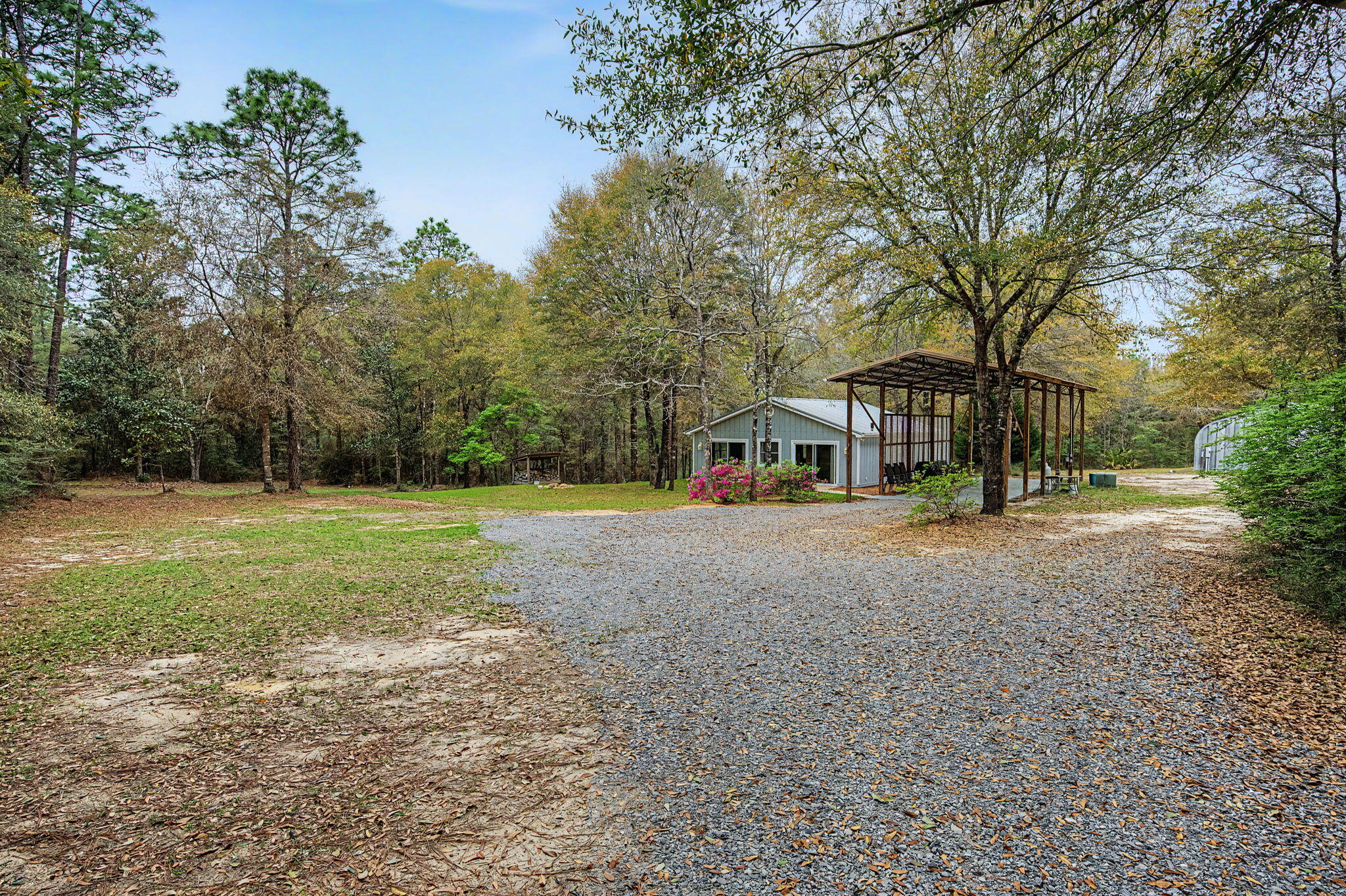 6730 Owens Road Laurel Hill, FL 32567 - Photo 1 of 36 a view of outdoor space with deck and trees