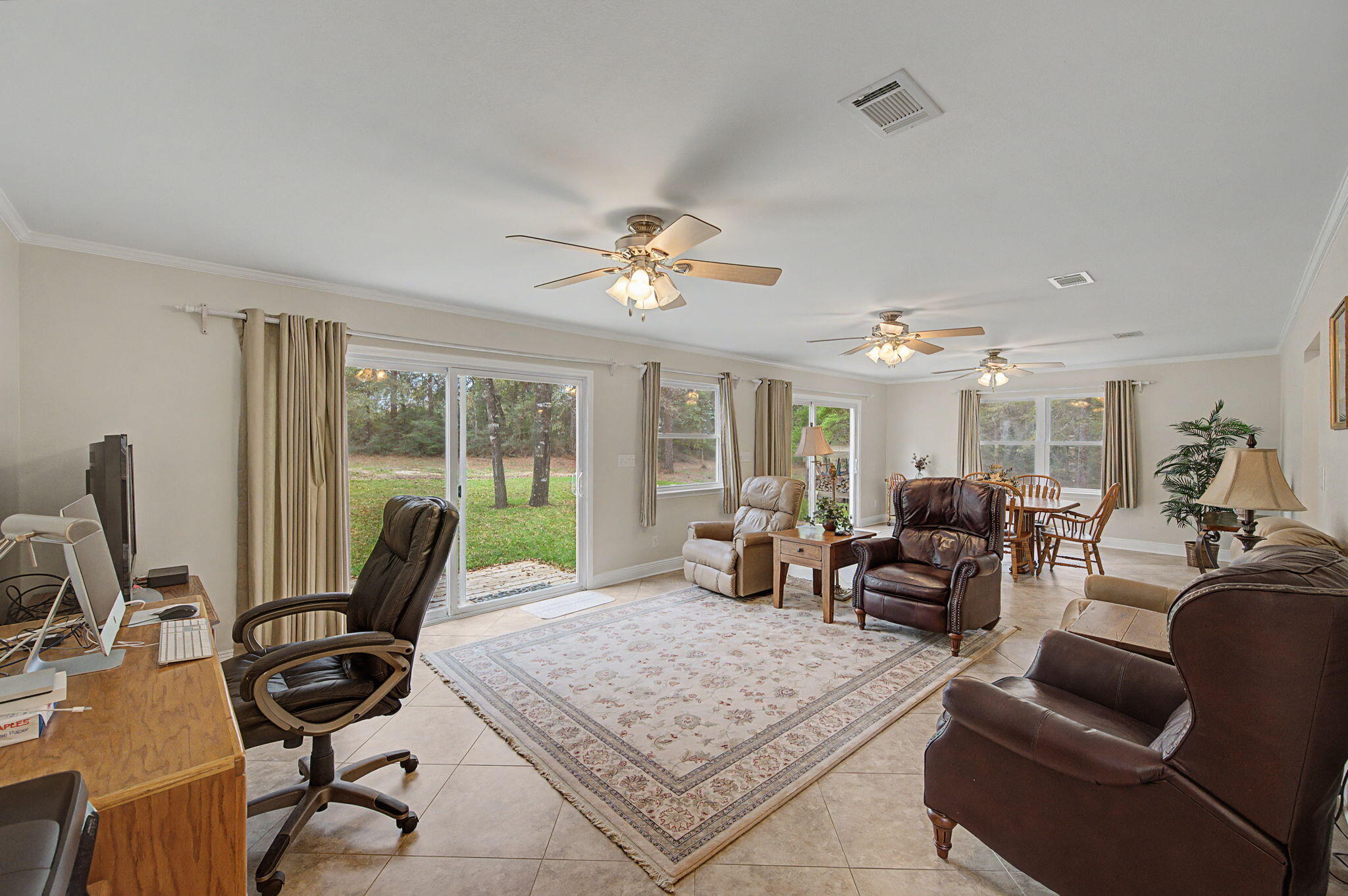 6730 Owens Road Laurel Hill, FL 32567 - Photo 14 of 36 a living room with furniture and floor to ceiling windows