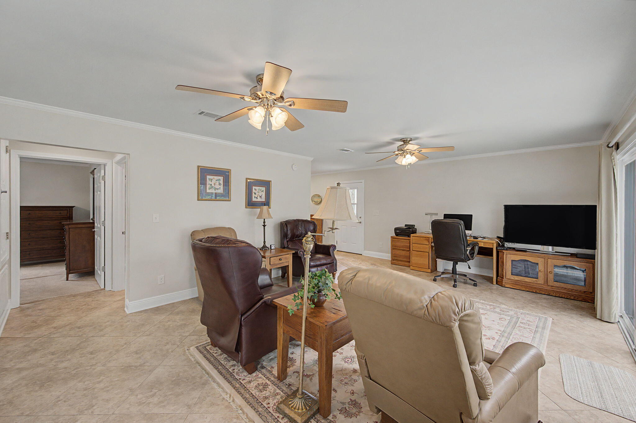 6730 Owens Road Laurel Hill, FL 32567 - Photo 16 of 36 a living room with furniture and a flat screen tv