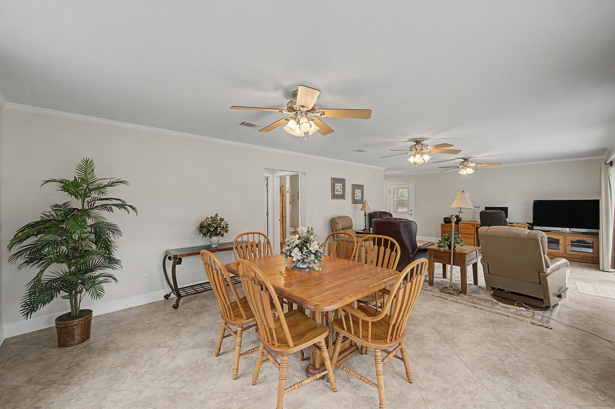 6730 Owens Road Laurel Hill, FL 32567 - Photo 19 of 36 a dining room with furniture and a potted plant