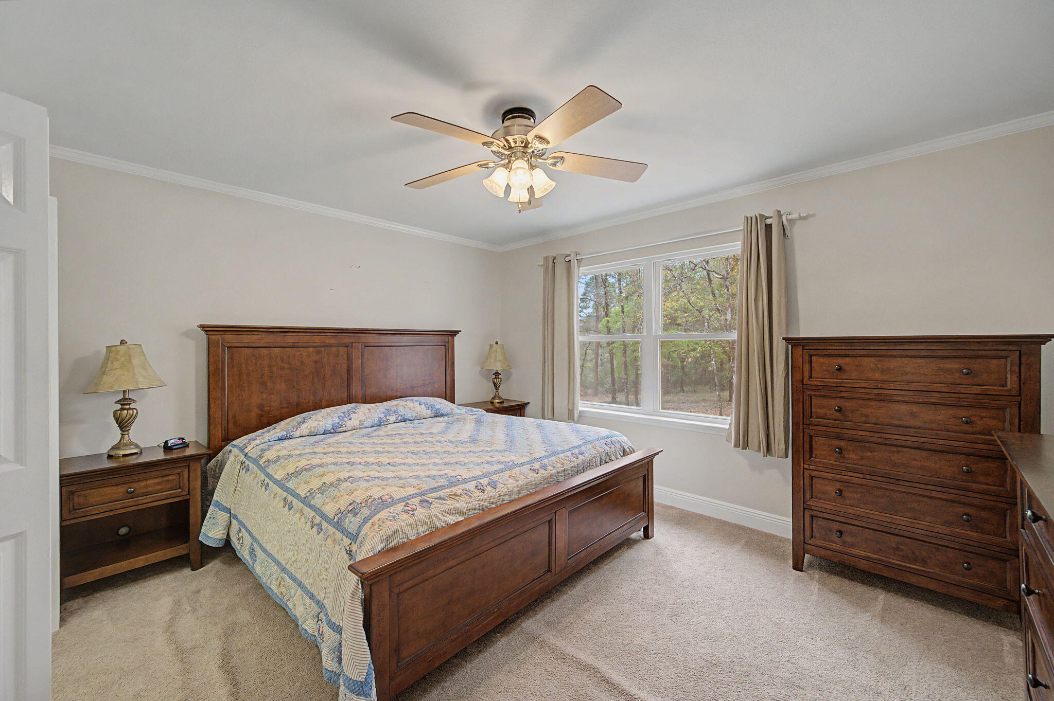6730 Owens Road Laurel Hill, FL 32567 - Photo 20 of 36 a bedroom with a bed and a ceiling fan