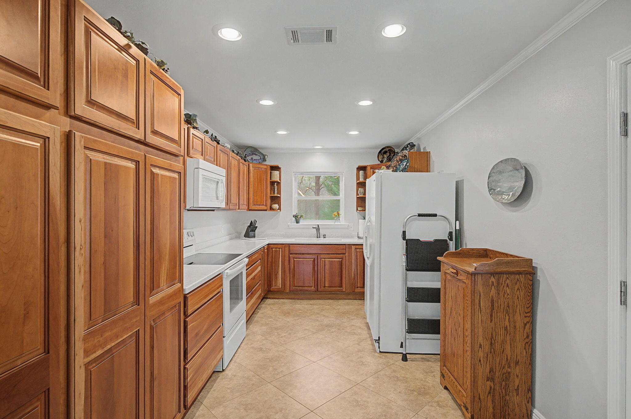 6730 Owens Road Laurel Hill, FL 32567 - Photo 26 of 36 a kitchen with stainless steel appliances granite countertop a refrigerator and a stove top oven