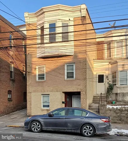 a front view of a house with parking space