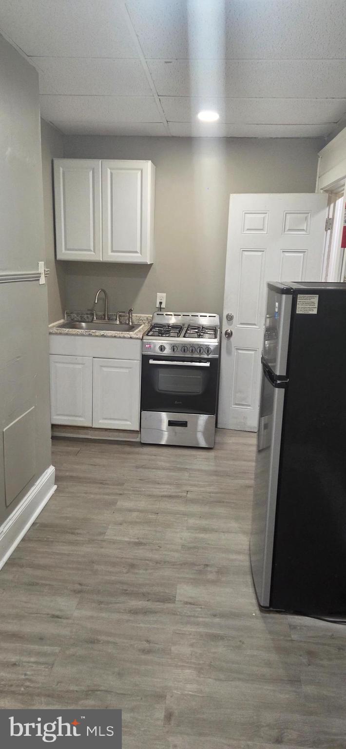 131 MacDade Boulevard, Unit 2F Collingdale, PA 19023 - Photo 3 of 14 a view of kitchen with granite countertop white cabinets and refrigerator