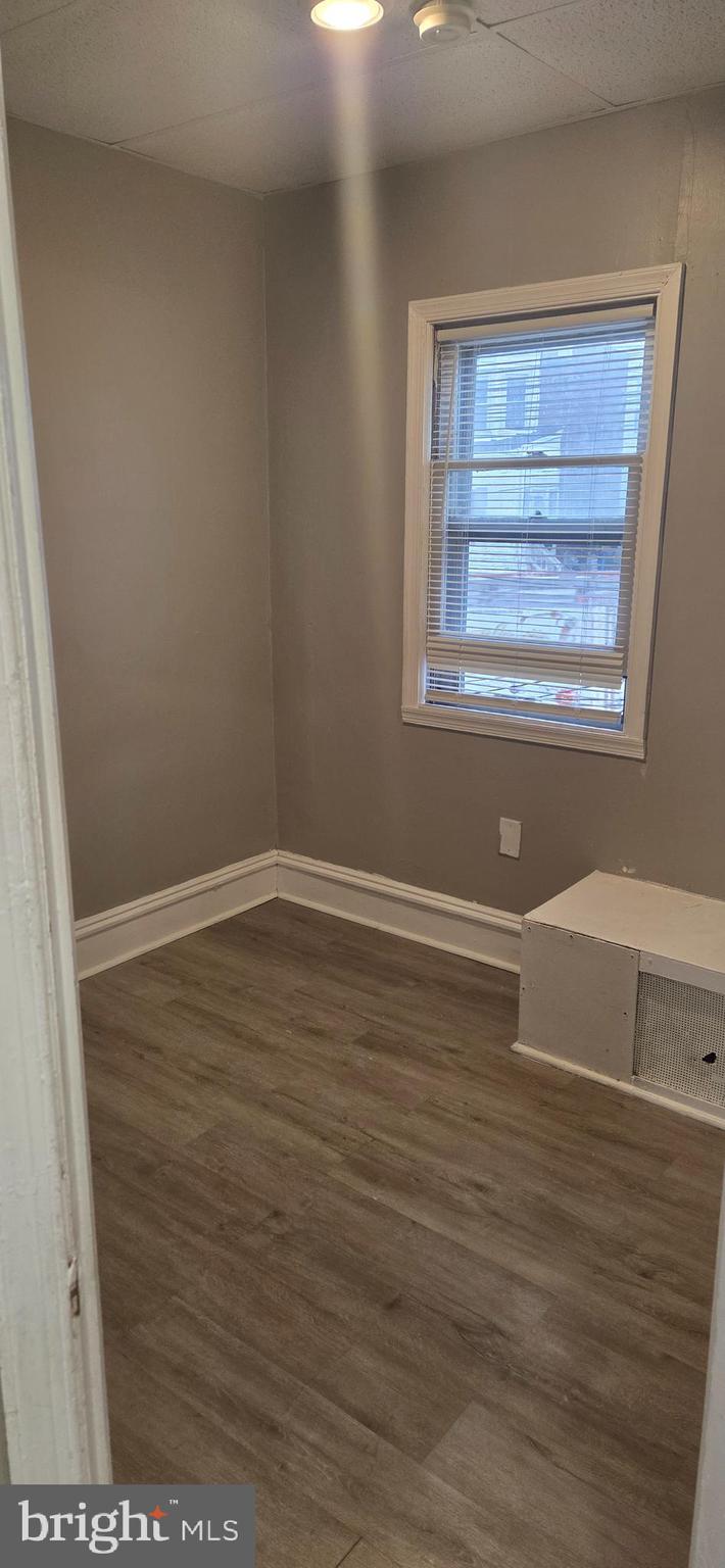 131 MacDade Boulevard, Unit 2F Collingdale, PA 19023 - Photo 5 of 14 a view of empty room with wooden floor and fan