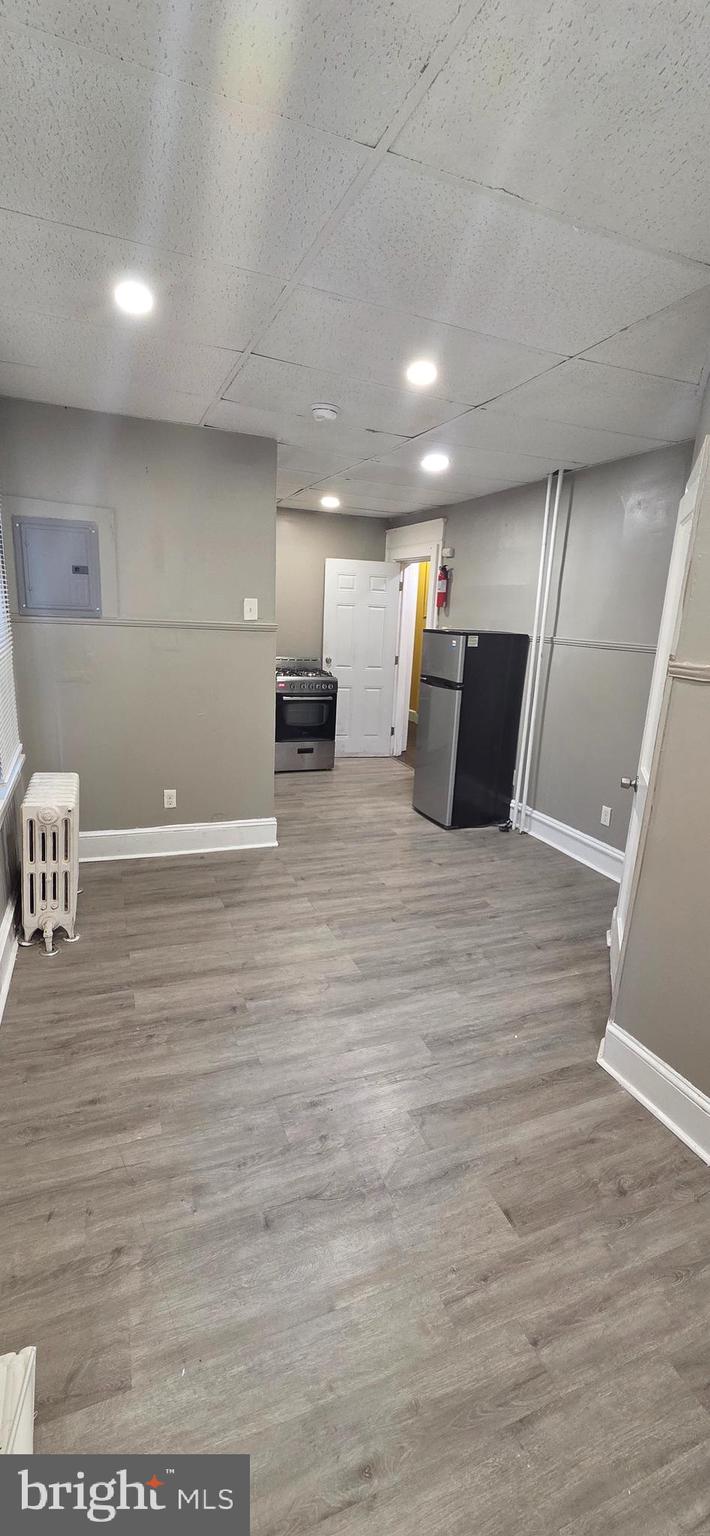 131 MacDade Boulevard, Unit 2F Collingdale, PA 19023 - Photo 8 of 14 a large room with wooden floor
