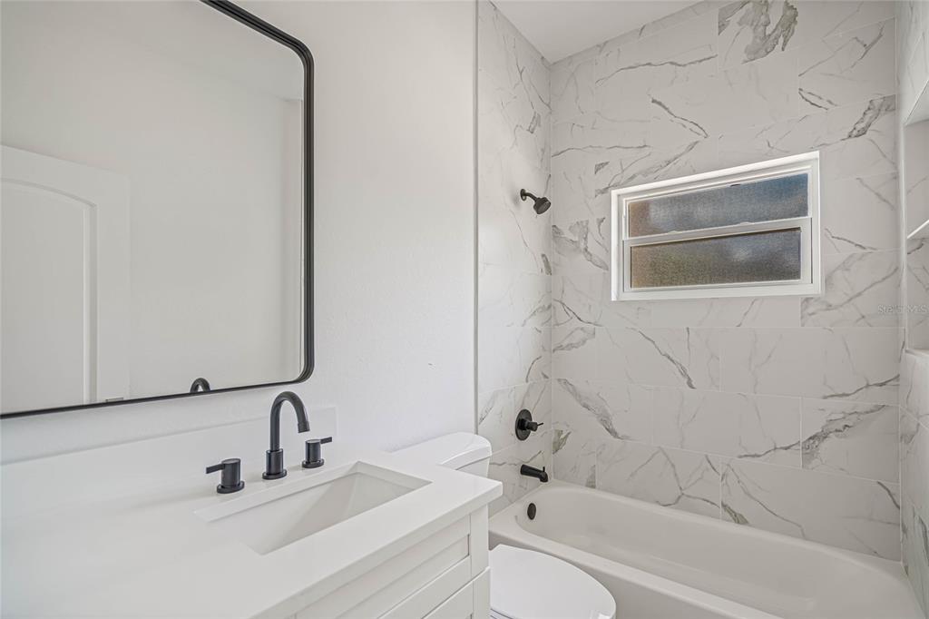 8001 Leonardo Street Sebring, FL 33872 - Photo 25 of 32 a bathroom with a sink and a mirror