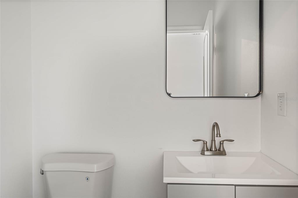 8001 Leonardo Street Sebring, FL 33872 - Photo 26 of 32 a bathroom with a sink and a toilet