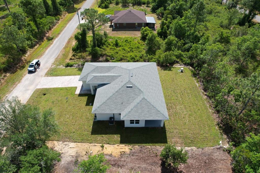 8001 Leonardo Street Sebring, FL 33872 - Photo 30 of 32 an aerial view of a house with a garden and lake view