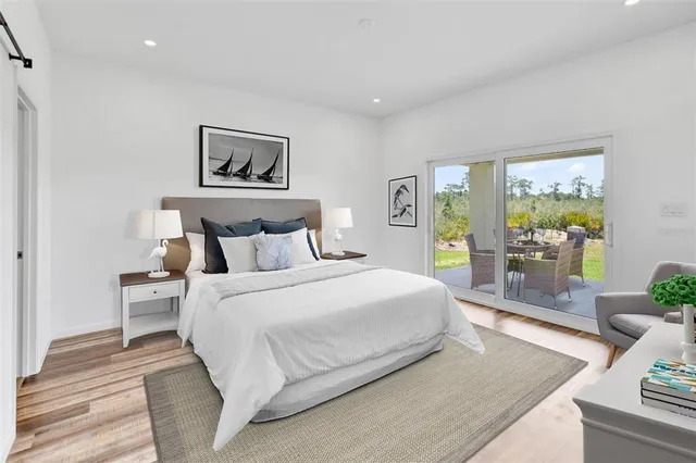 a bedroom with a large bed and a painting on the wall