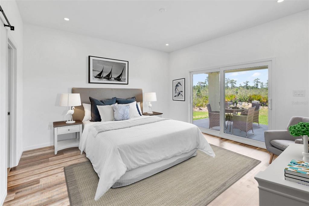 8001 Leonardo Street Sebring, FL 33872 - Photo 4 of 32 a bedroom with a large bed and a painting on the wall