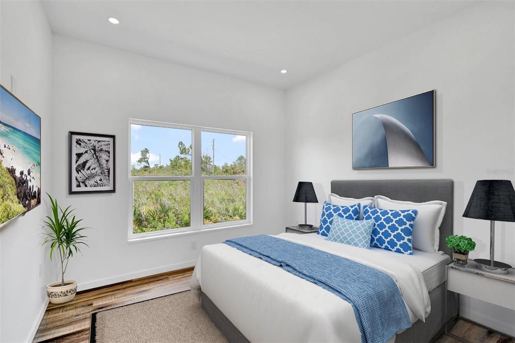 8001 Leonardo Street Sebring, FL 33872 - Photo 6 of 32 a bedroom with a large bed and a window