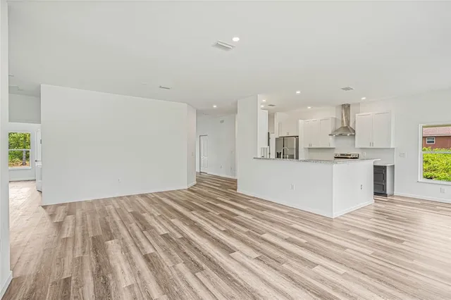a view of kitchen and kitchen with wooden floor