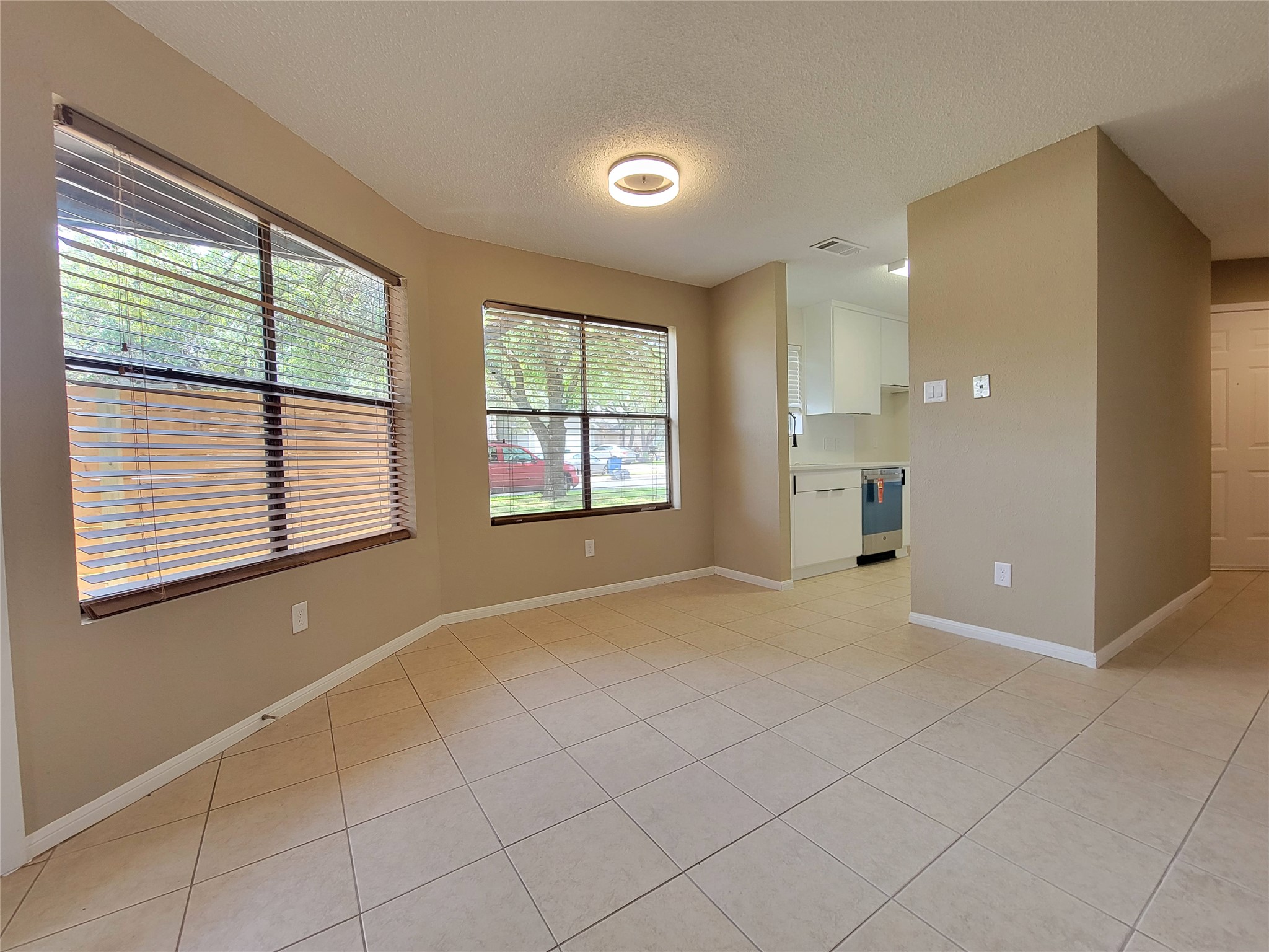 8706 Schick Road, Unit A Austin, TX 78729 - Photo 8 of 33 Natural light floods this living area, offering clear views of the adjacent kitchen.