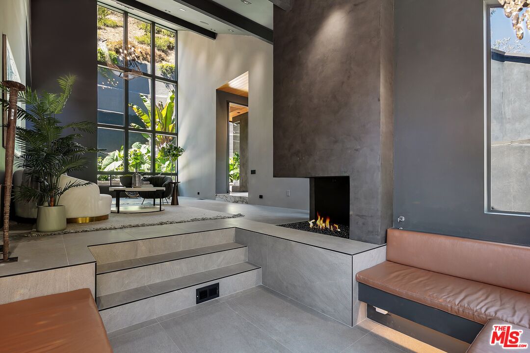 2001 Roscomare Road Los Angeles, CA 90077 - Photo 14 of 62 a living room with furniture and a flat screen tv