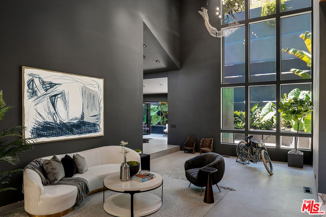 2001 Roscomare Road Los Angeles, CA 90077 - Photo 15 of 62 a living room with furniture and a floor to ceiling window