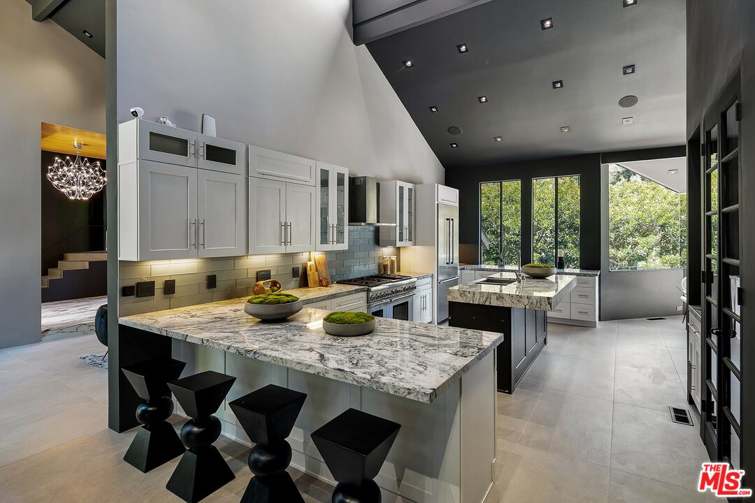 2001 Roscomare Road Los Angeles, CA 90077 - Photo 17 of 62 a living room with stainless steel appliances granite countertop furniture a rug kitchen view and a large window