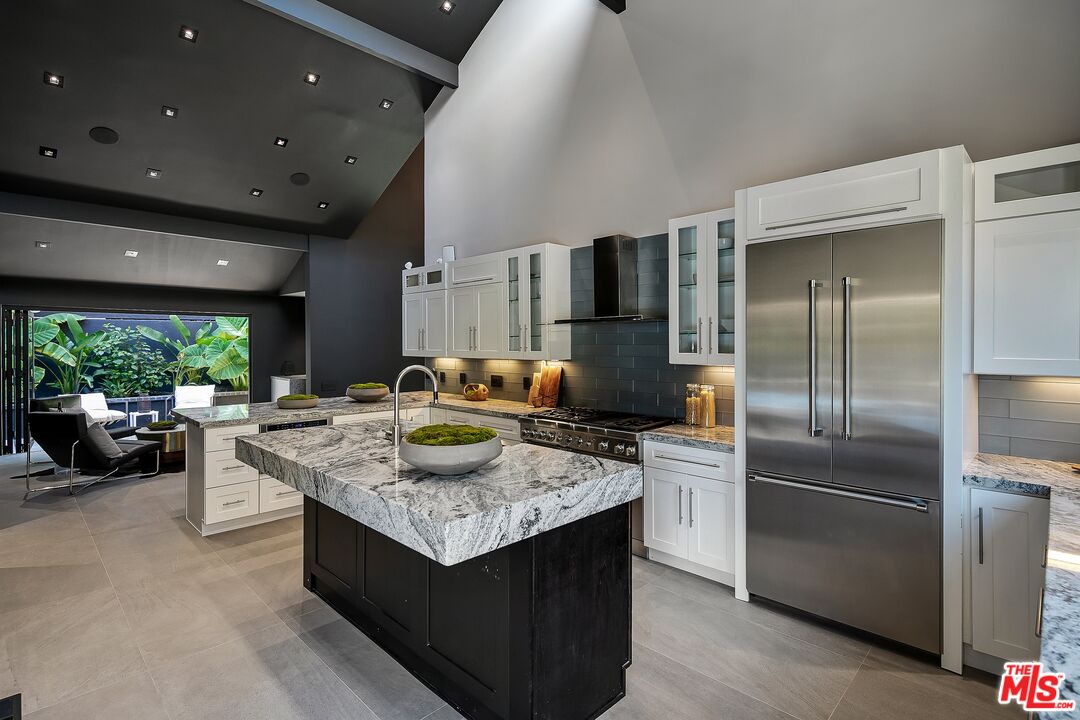 2001 Roscomare Road Los Angeles, CA 90077 - Photo 18 of 62 a kitchen with kitchen island stainless steel appliances a sink stove and refrigerator