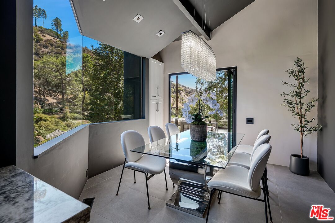 2001 Roscomare Road Los Angeles, CA 90077 - Photo 20 of 62 a dining room with furniture and wooden floor