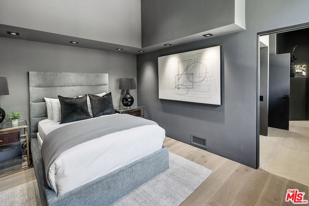 2001 Roscomare Road Los Angeles, CA 90077 - Photo 35 of 62 a bedroom with a bed and a painting on the wall