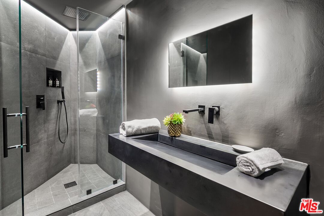 2001 Roscomare Road Los Angeles, CA 90077 - Photo 37 of 62 a bathroom with a sink and mirror