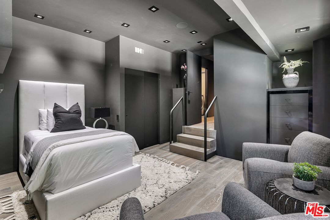 2001 Roscomare Road Los Angeles, CA 90077 - Photo 39 of 62 a bedroom with a bed couch and mirror