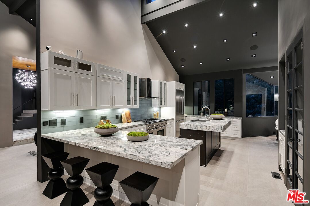 2001 Roscomare Road Los Angeles, CA 90077 - Photo 46 of 62 a dining hall with stainless steel appliances granite countertop a dining table and chairs