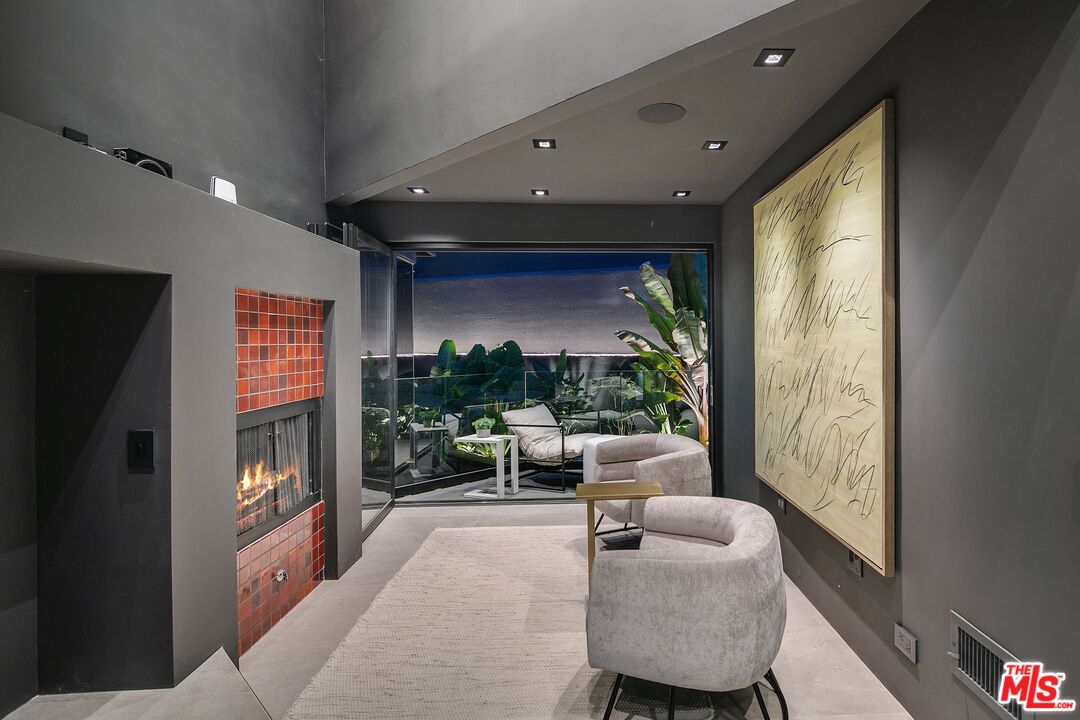 2001 Roscomare Road Los Angeles, CA 90077 - Photo 48 of 62 a living room with furniture and a flat screen tv