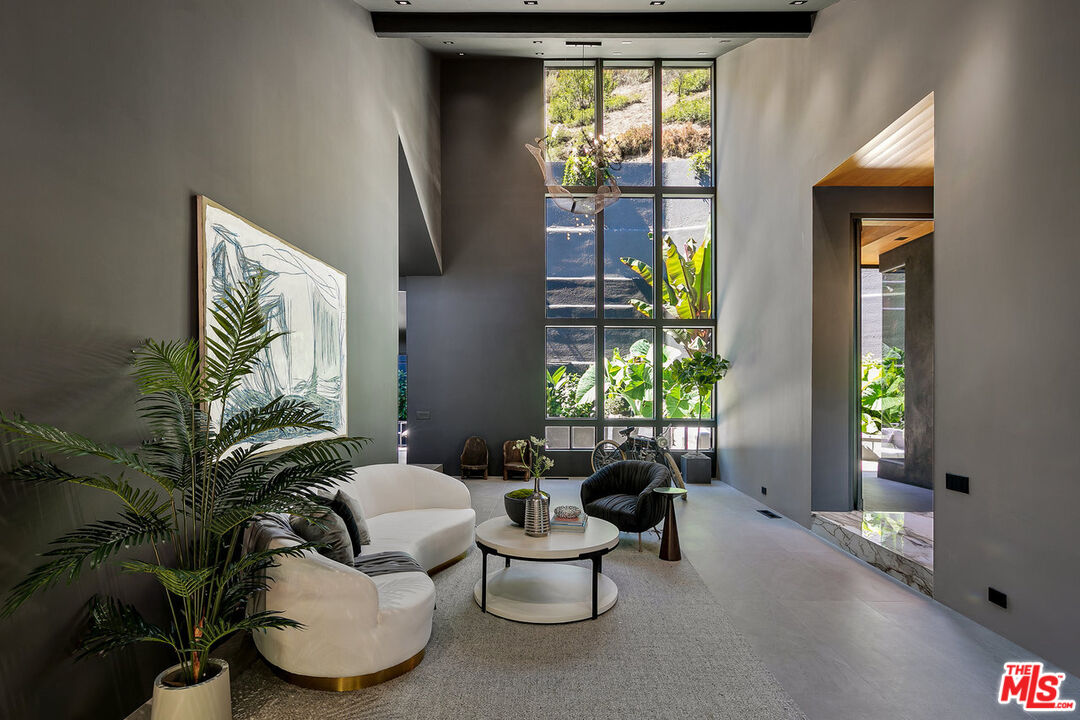 2001 Roscomare Road Los Angeles, CA 90077 - Photo 52 of 62 a living room with furniture and a potted plant