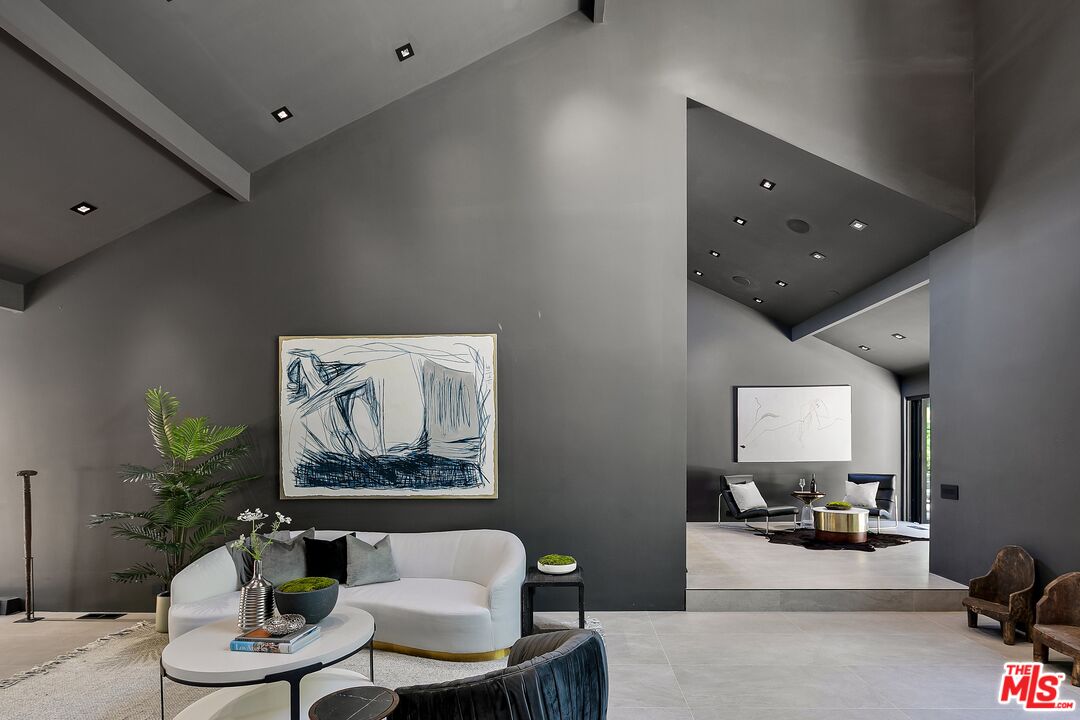 2001 Roscomare Road Los Angeles, CA 90077 - Photo 9 of 62 a living room with furniture and a painting on the wall