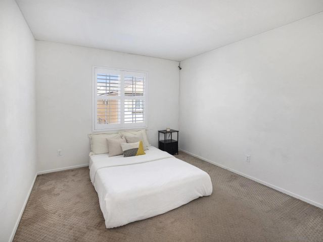 a view of a hallway with closet and cabinet