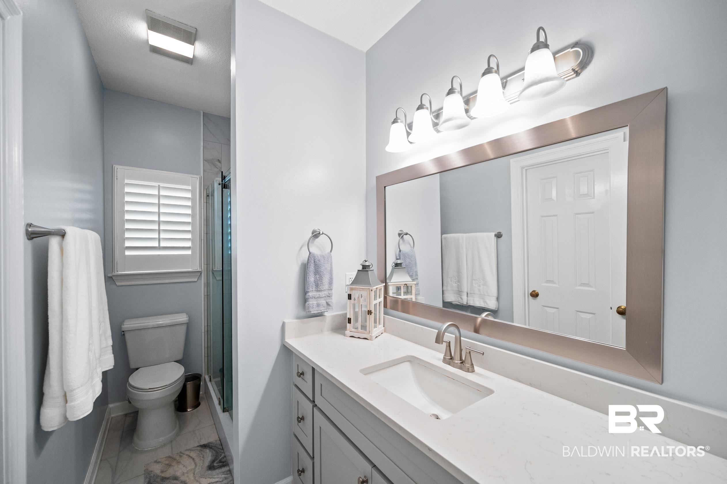 6638 Jackson Square Daphne, AL 36526 - Photo 6 of 62 Bathroom with vanity, toilet, tile patterned floors, and an enclosed shower