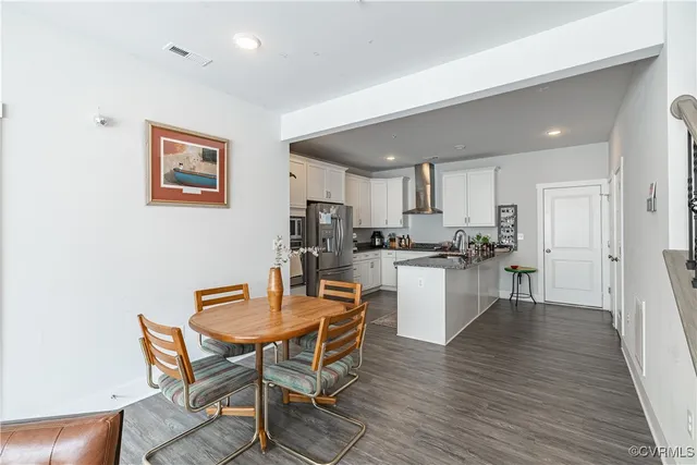 a dining room with furniture window and wooden floor