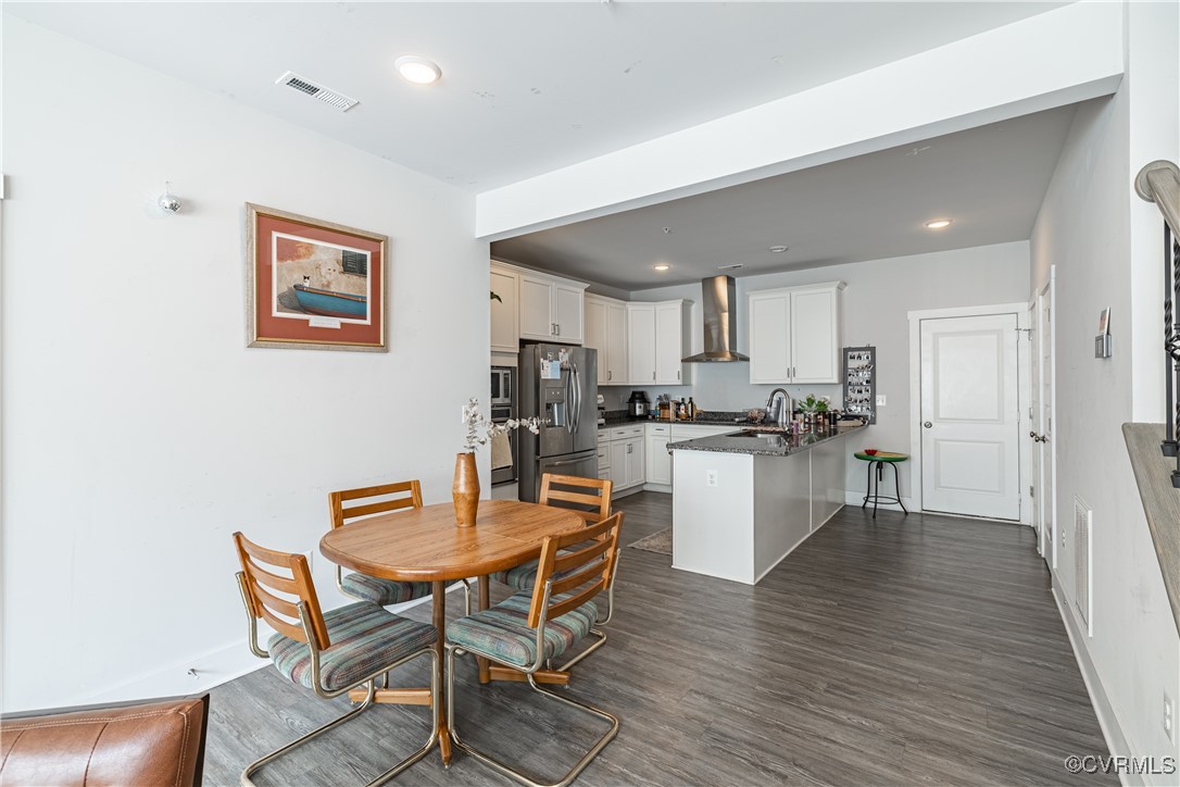 5329 Old Main Street, Unit A Henrico, VA 23231 - Photo 15 of 39 a kitchen with a dining table chairs and wooden floor