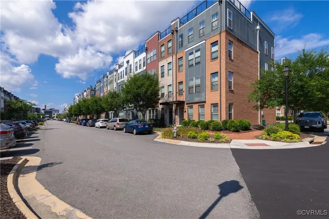 a city street lined with buildings and trees