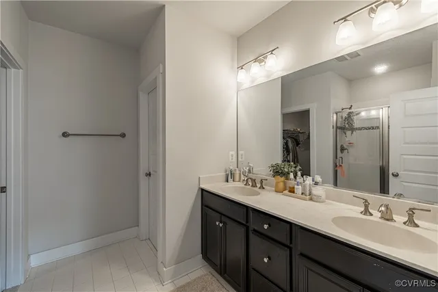 a bathroom with a glass shower door and a mirror