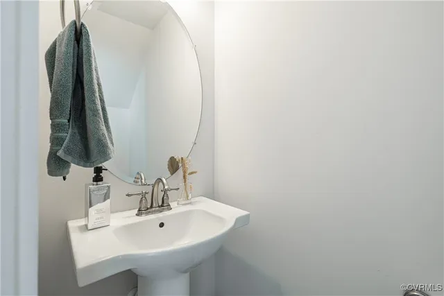 a view of a brick house with a yard and plants