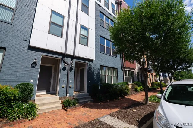 a view of a patio with couches table and chairs and potted plants