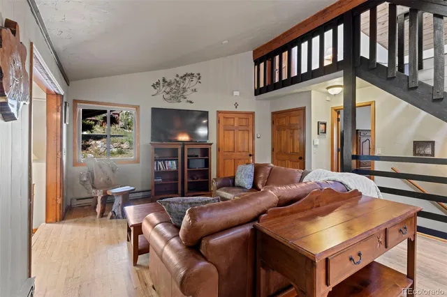 a living room with furniture fireplace and a window