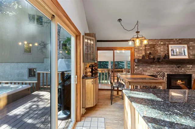 a living room with furniture a large window and a fireplace