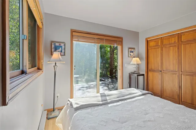 a bedroom with a bed and a large window