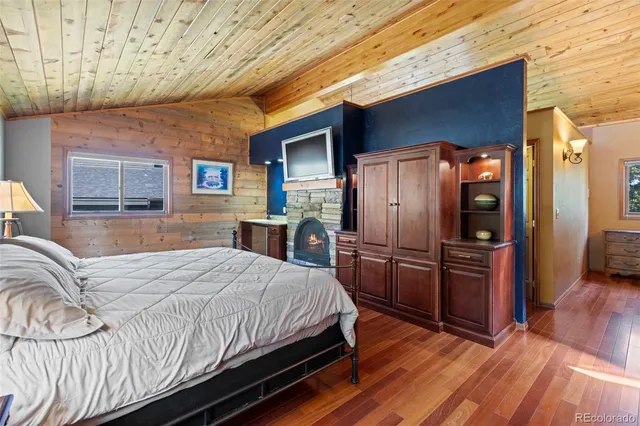 a bedroom with a bed closet and wooden floor